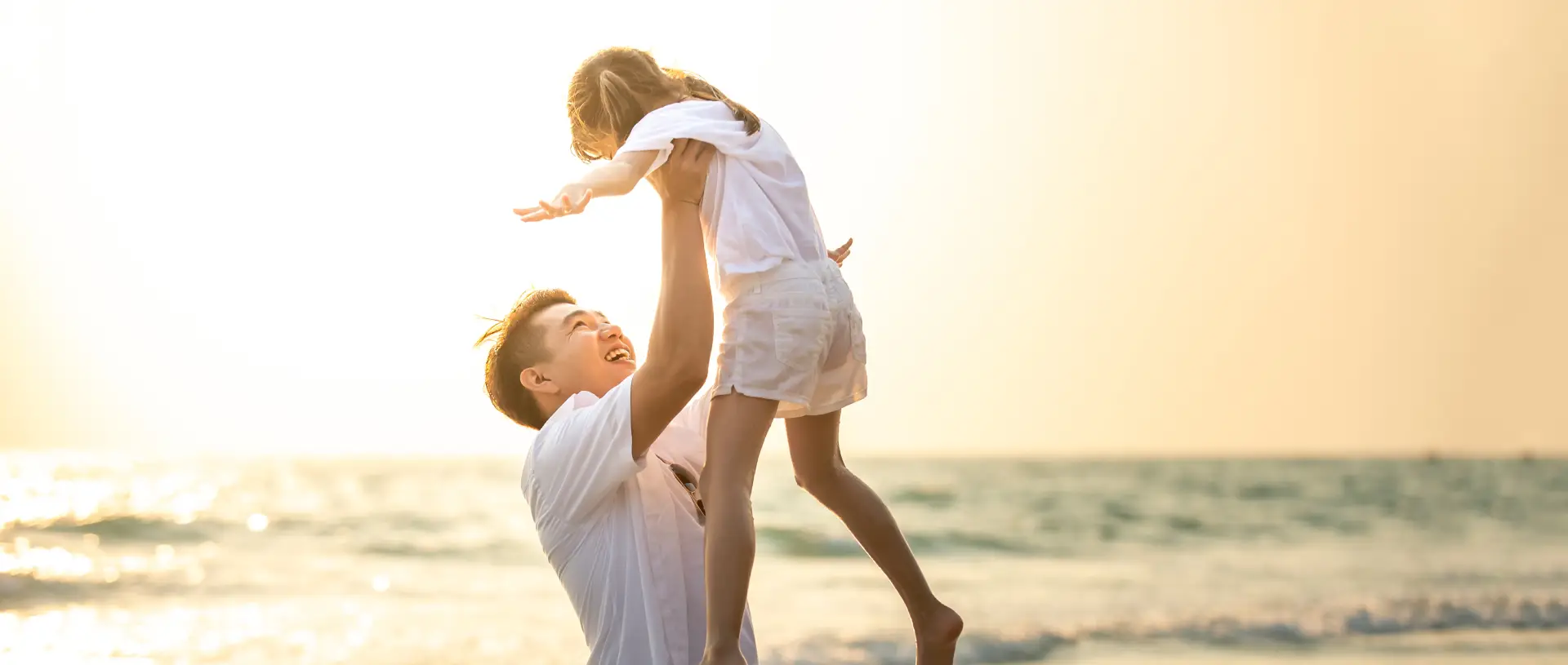 father-daughter-having-fun-beach-sunset
